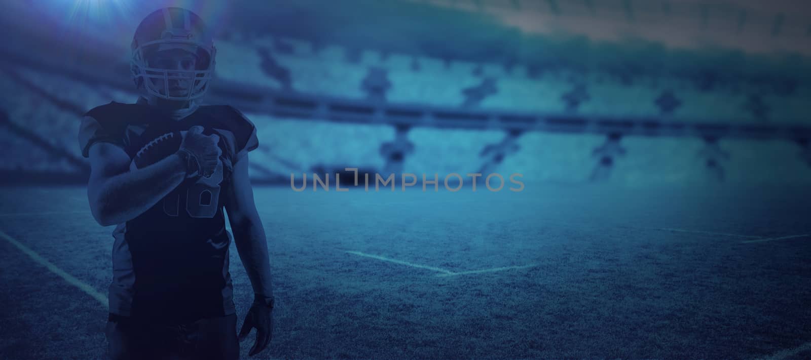 American football player in helmet holding rugby ball against digital image of rugby stadium