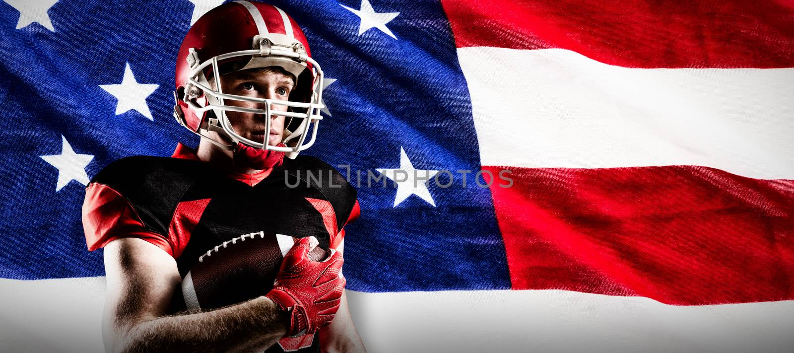 American football player in helmet standing with rugby ball against close-up of an american flag
