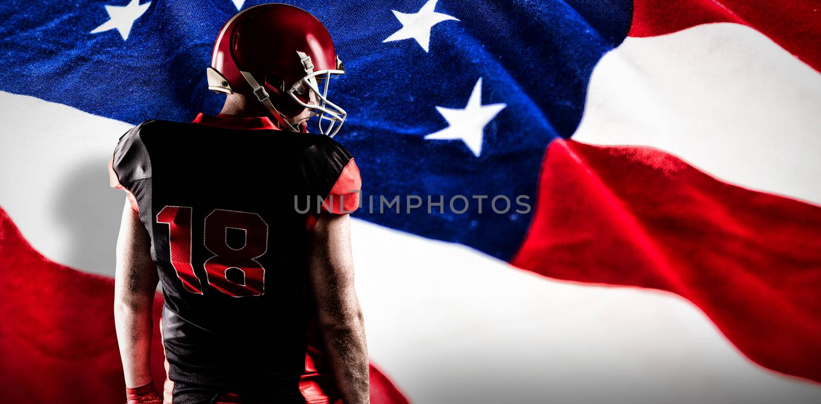 American football player standing in rugby helmet against american flag with stars and stripes