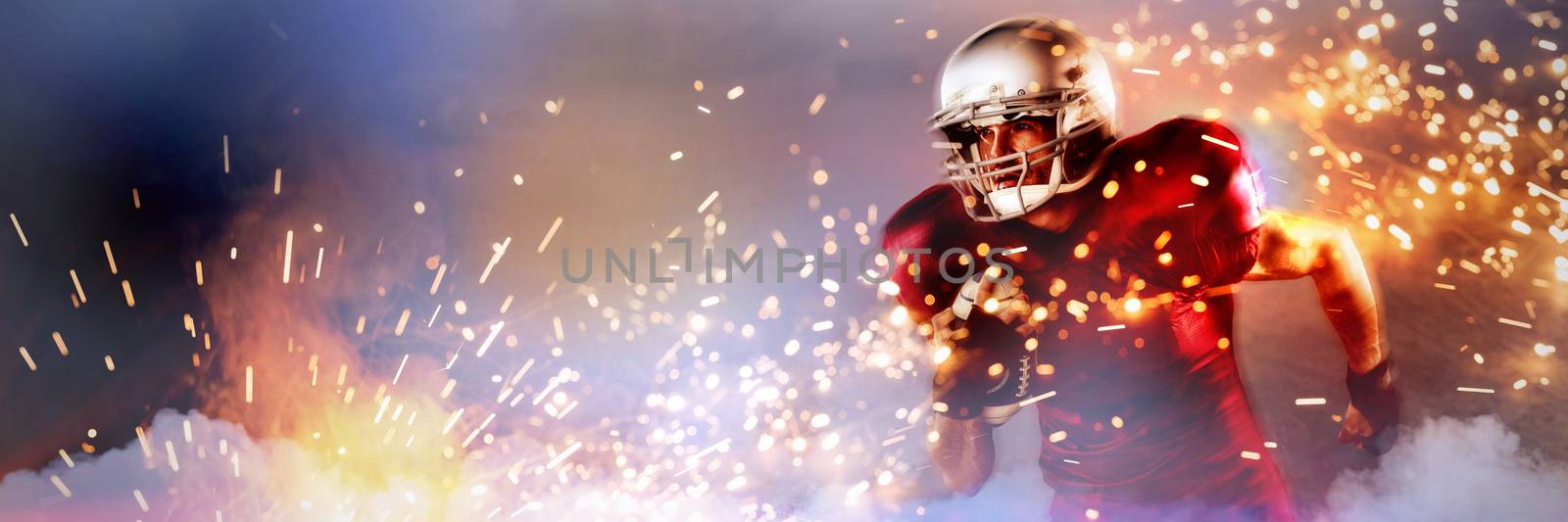 Determined American football player holding ball against firework bursting sparkle background
