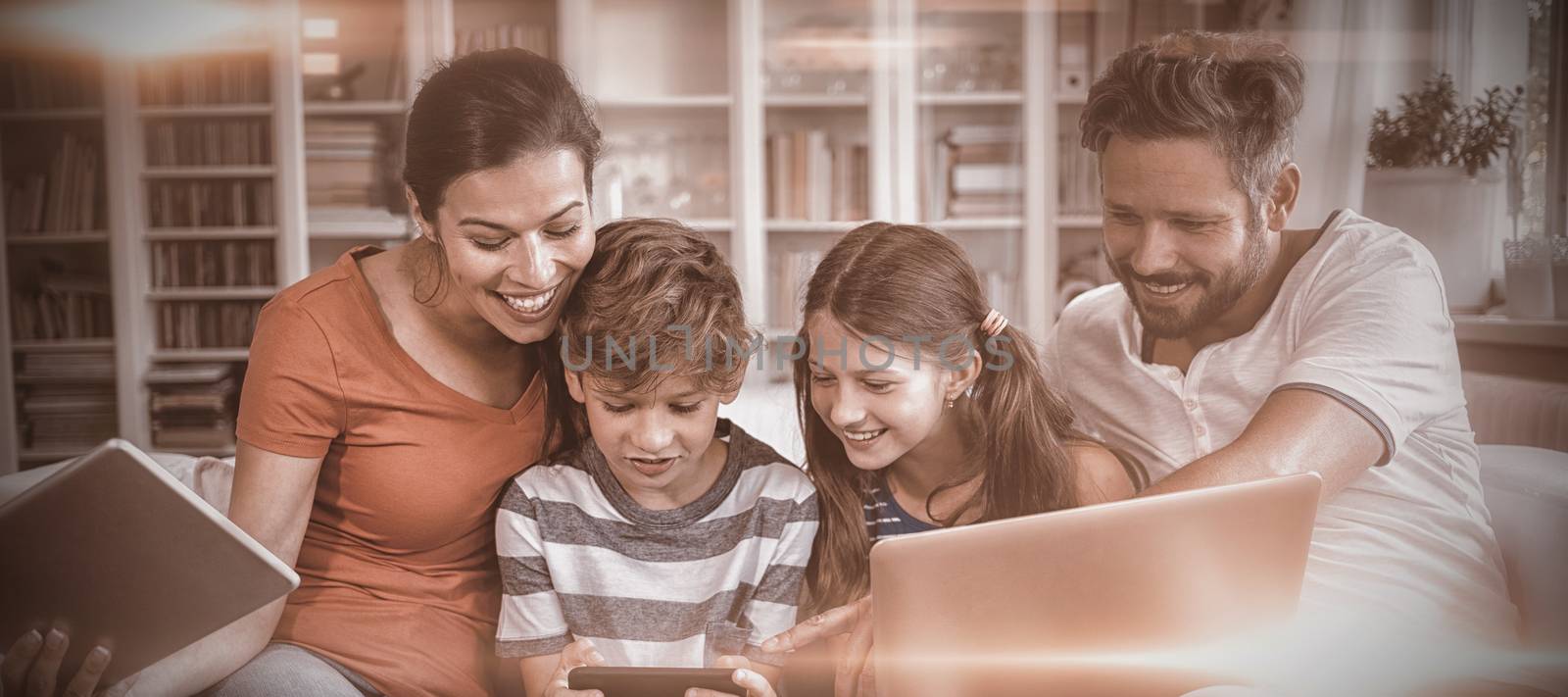 Happy family using technologies while sitting on sofa  by Wavebreakmedia