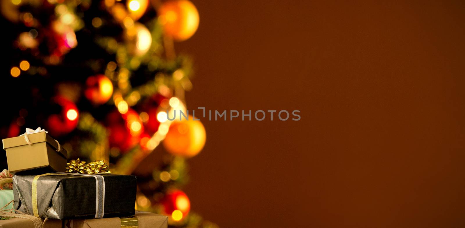 Christmas decorations hanging on wall against copy space with a christmas tree