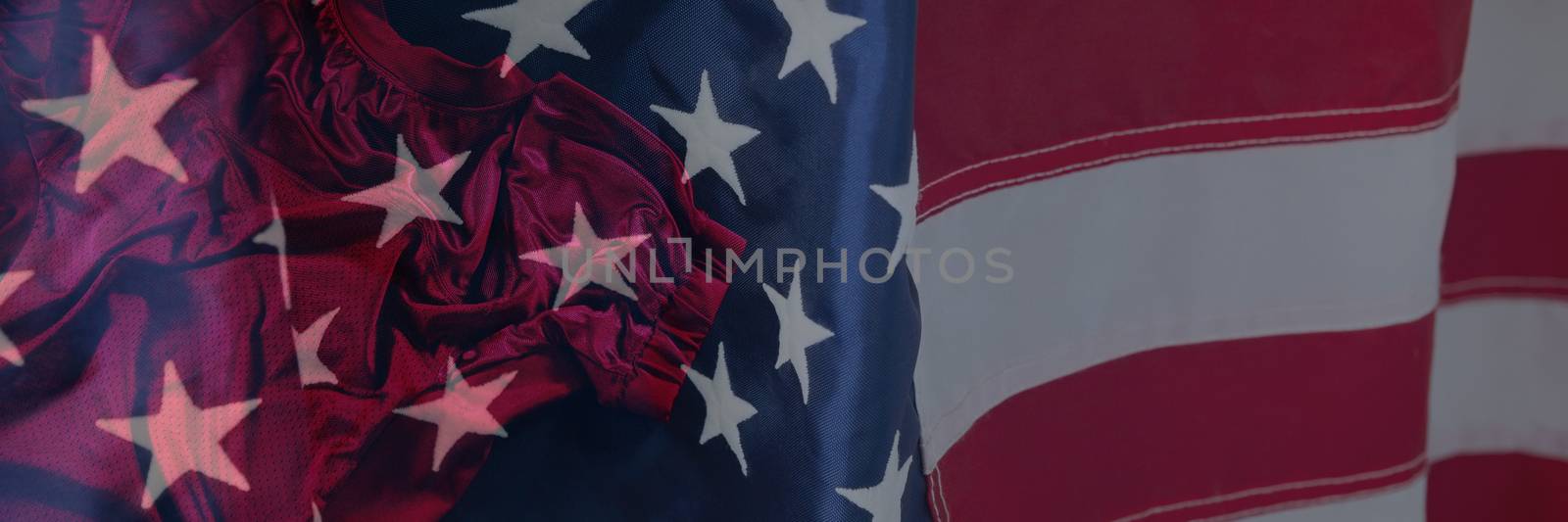 Close-up of an American flag against rugby jersey against black background