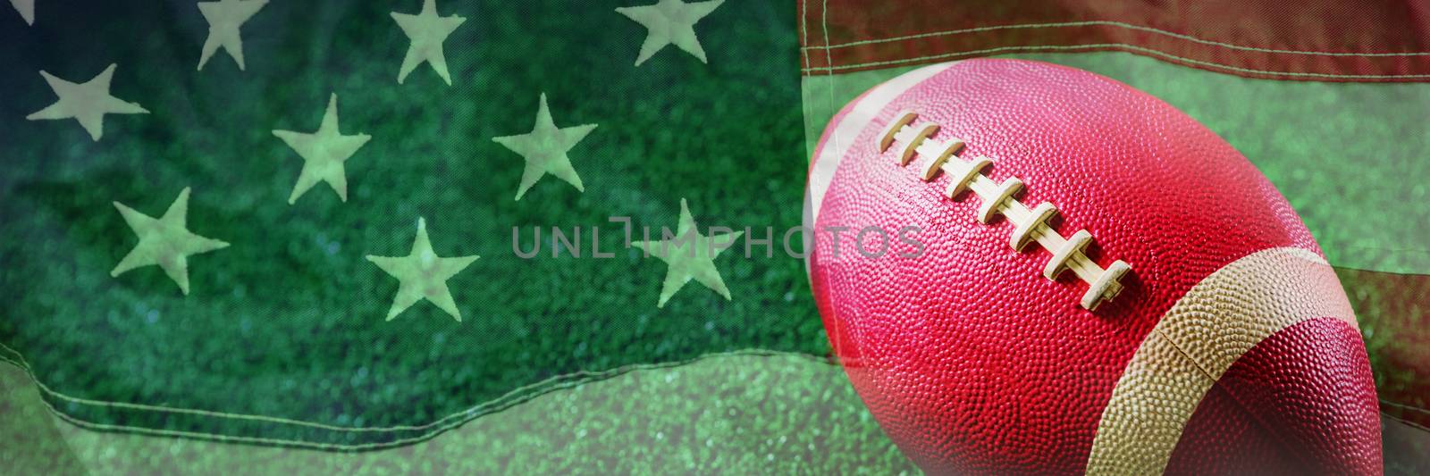 Close-up of American football against full frame of american flag