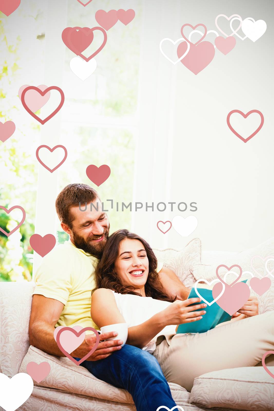 Valentines heart design against man holding a cup of coffee while woman reading book