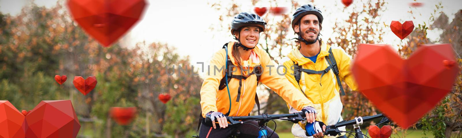Red heart with white blackground against biker couple cycling in countryside