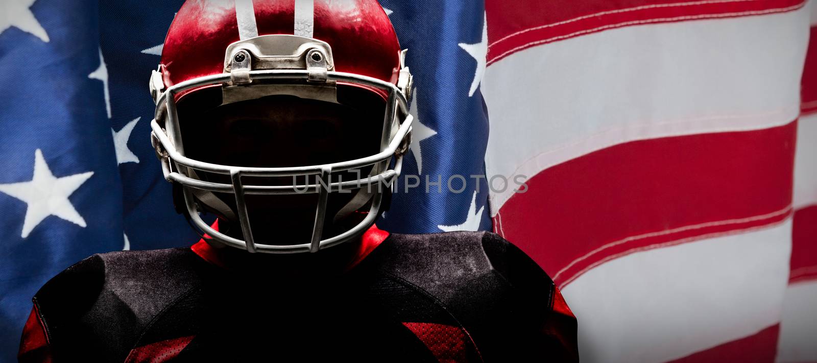 American football player standing in rugby helmet against close-up of an american flag