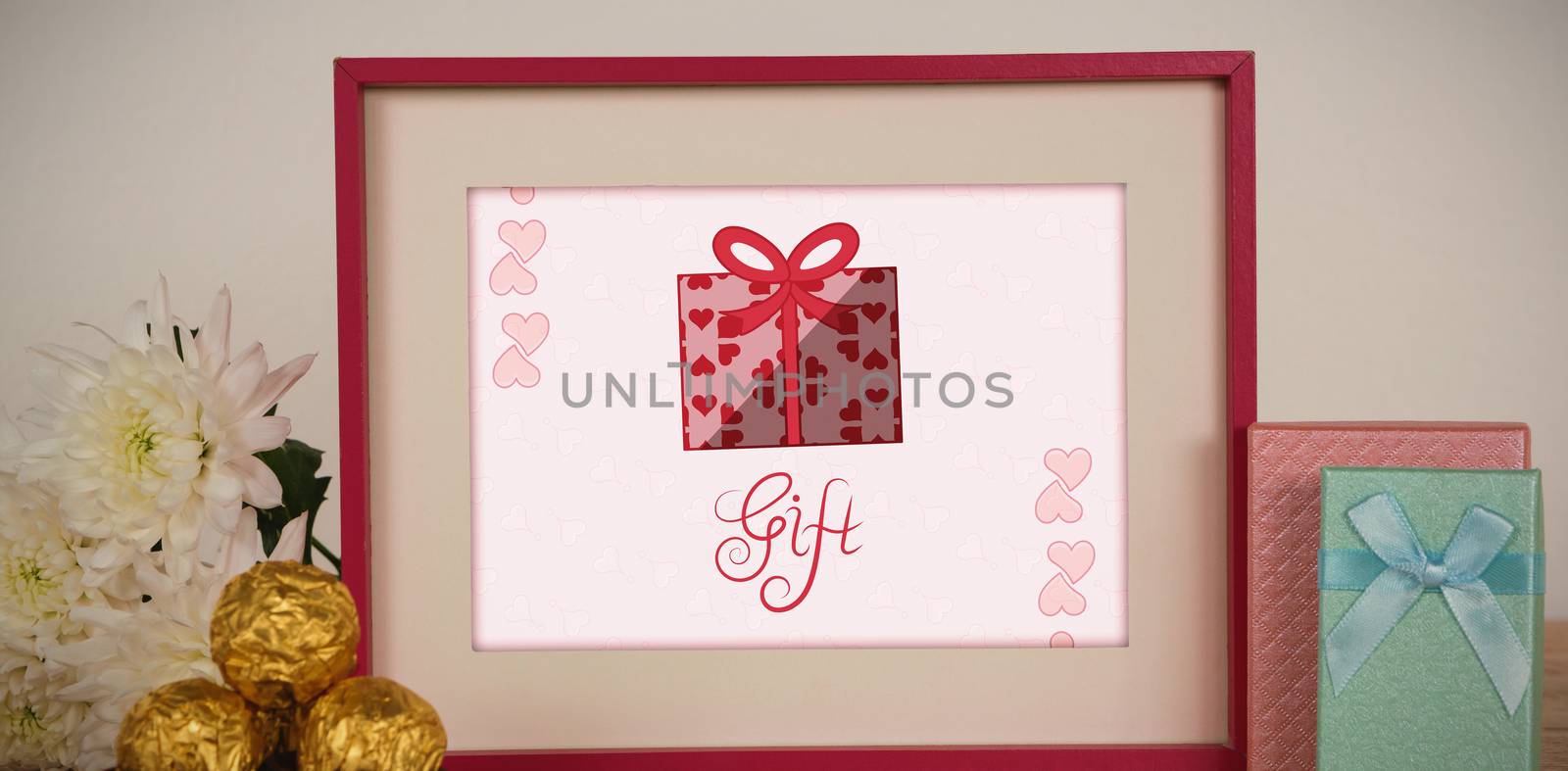 Cute Valentines Day message in Frame on desk with gifts and petals