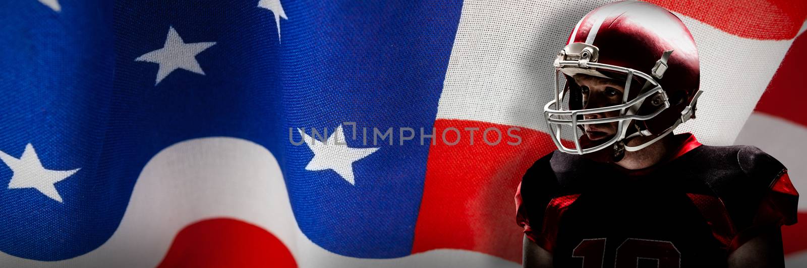 American football player standing in helmet against close-up of an american flag