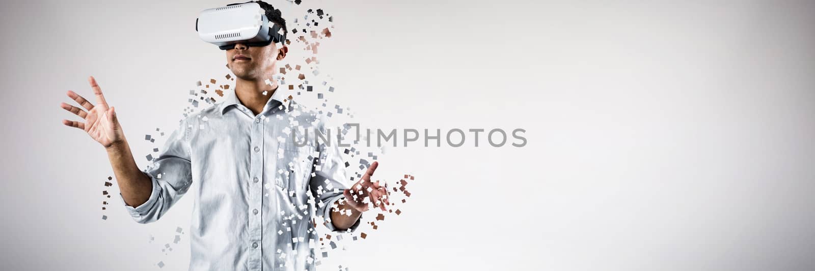Man using virtual reality headset against grey background