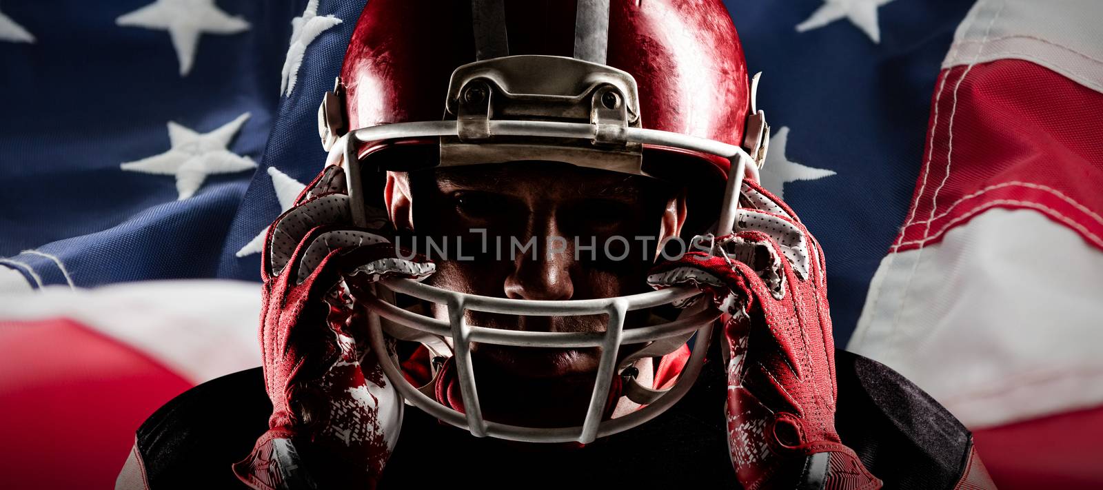 American football player standing with rugby helmet against full frame of american flag