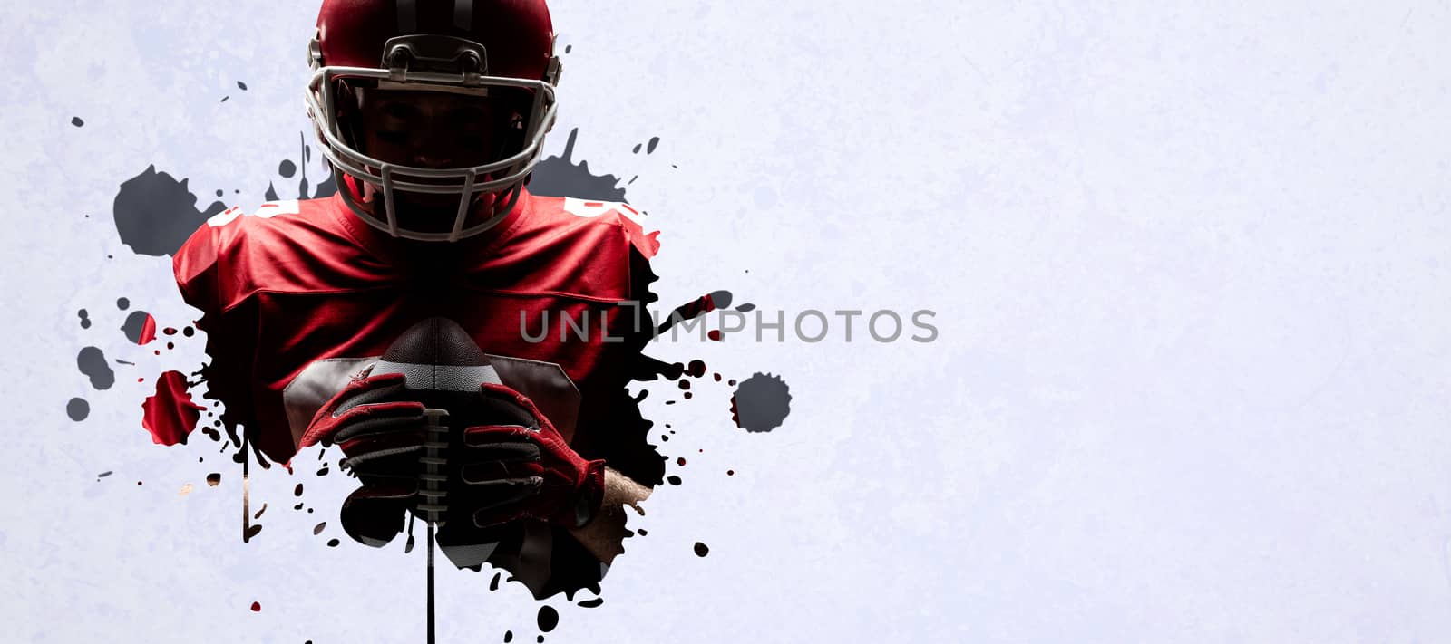 Composite image of american football player standing with rugby helmet and ball by Wavebreakmedia