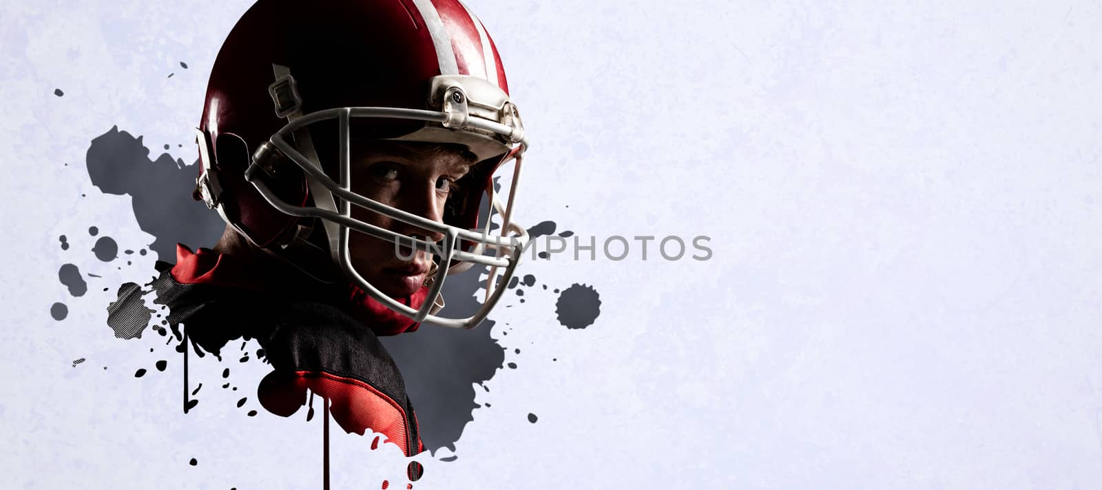 American football player standing in helmet  against grey vignette