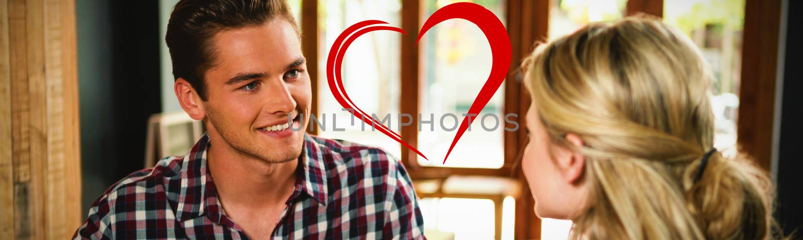 Heart against man having coffee while talking with woman in cafe