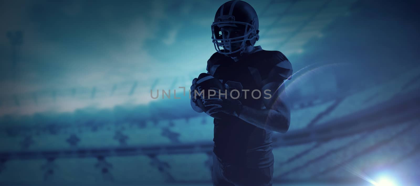 Composite image of american football player in helmet holding rugby ball by Wavebreakmedia