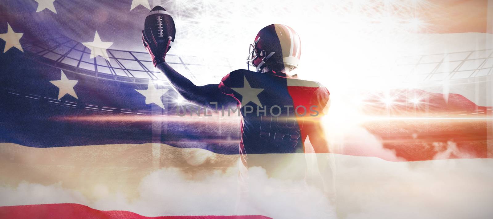 American football player in helmet holding rugby ball against close-up of an american flag