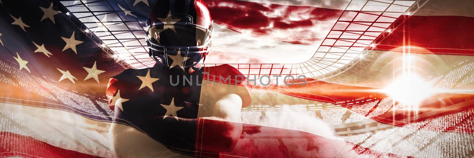 American football player standing with arms crossed against close-up of an american flag