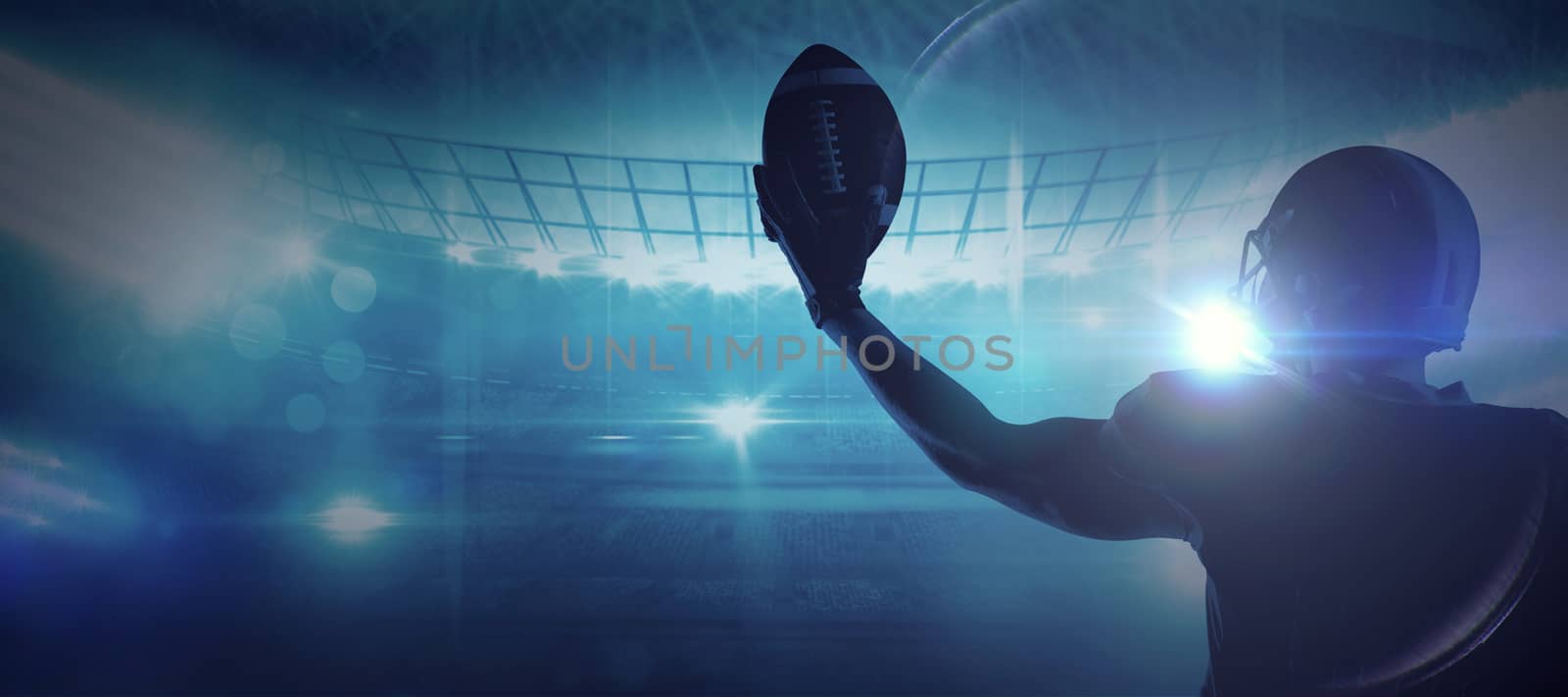 Composite image of american football player in helmet holding rugby ball by Wavebreakmedia