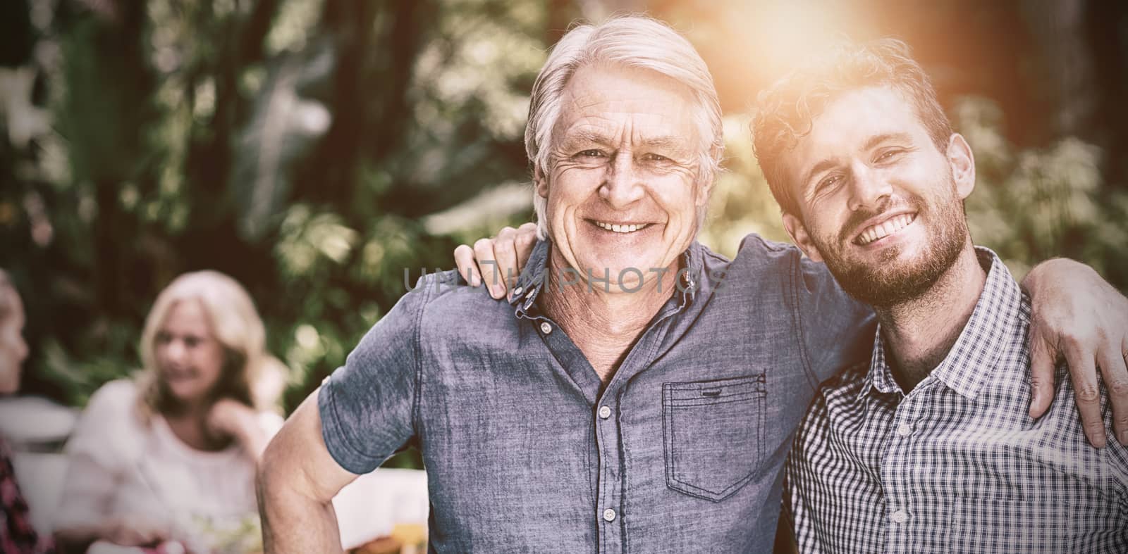 Happy father and son standing in yard  by Wavebreakmedia