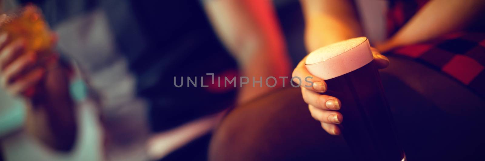 Woman holding a glass of drink in bar