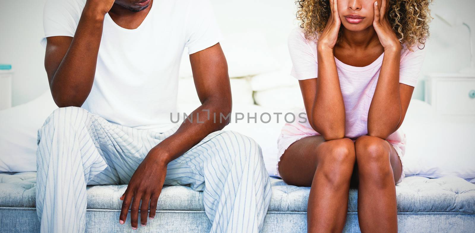 Upset couple ignoring each other after fight on bed by Wavebreakmedia