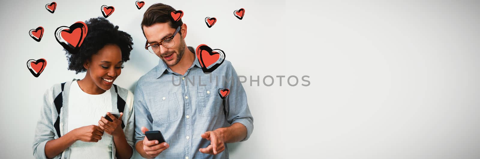 Red Hearts against man and woman using mobile phone