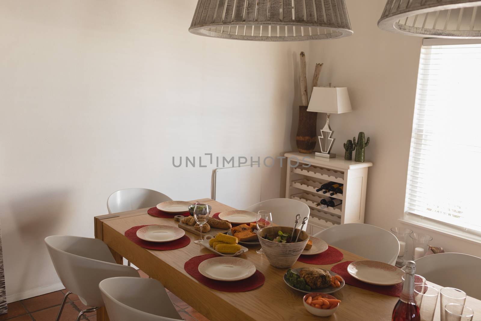 High angle view of dining table with plates and food at home