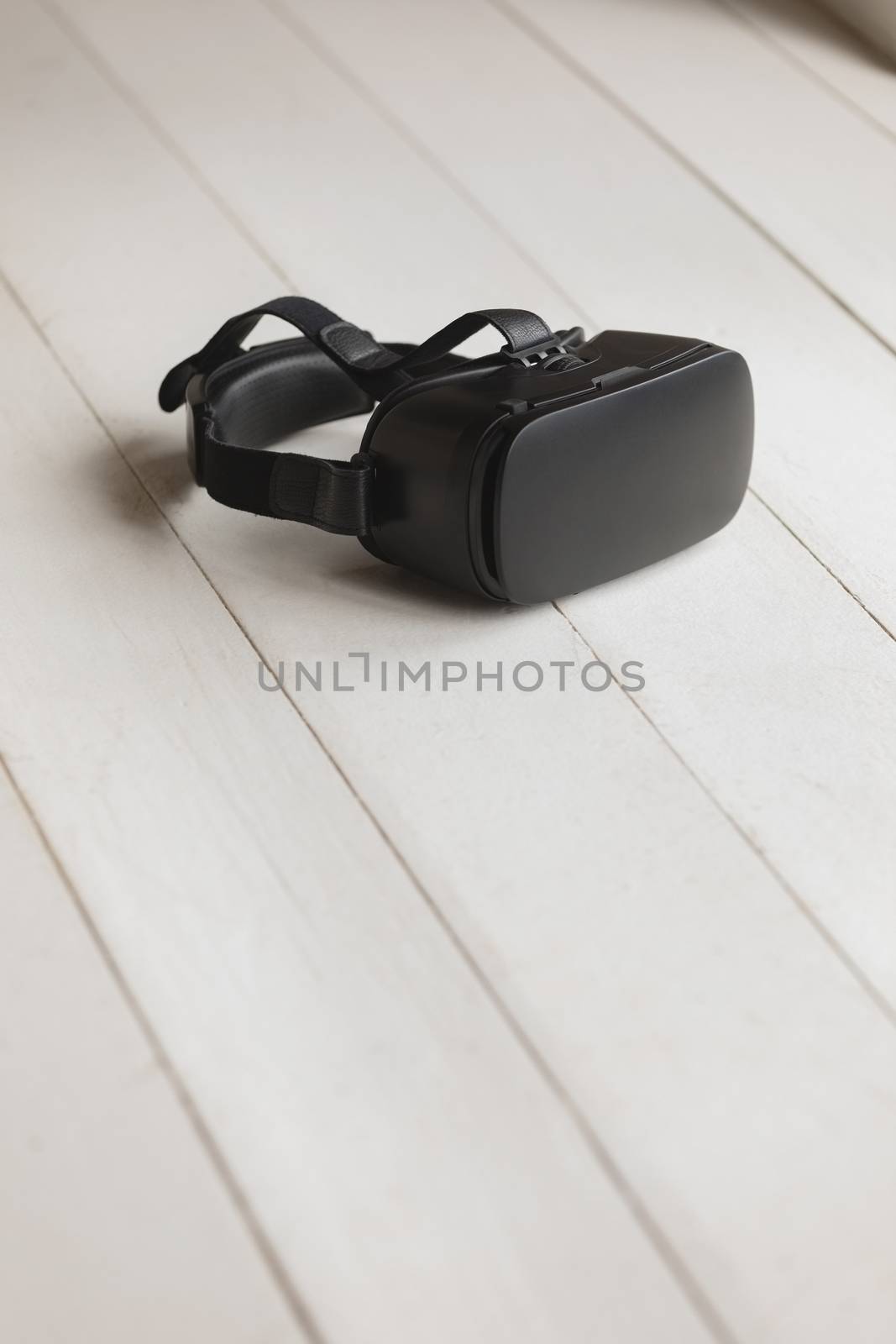 Close-up of virtual reality headset placed on the floor at home