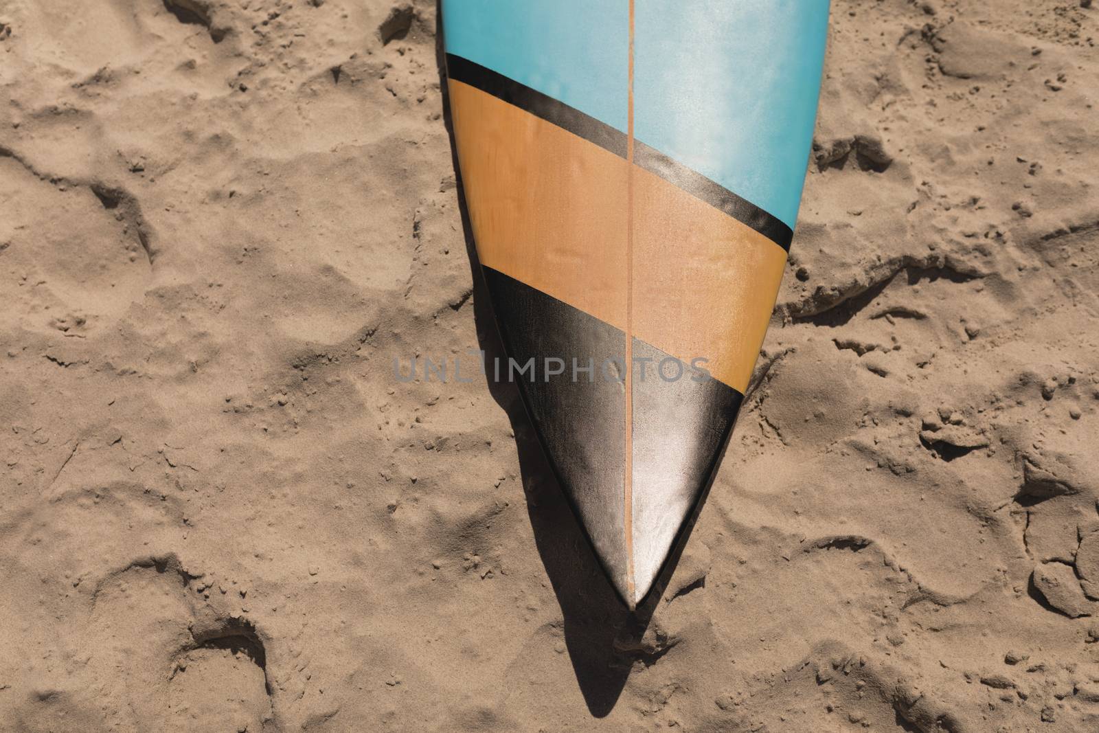 Close-up of surfboard on beach in the sunshine