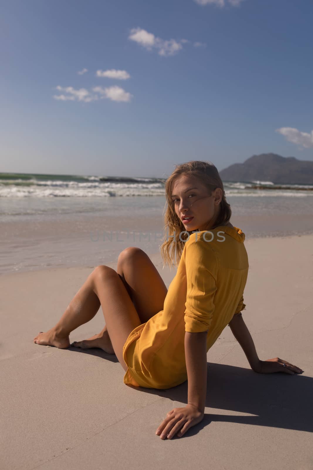 Portrait of young woman relaxing at beach on a sunny day