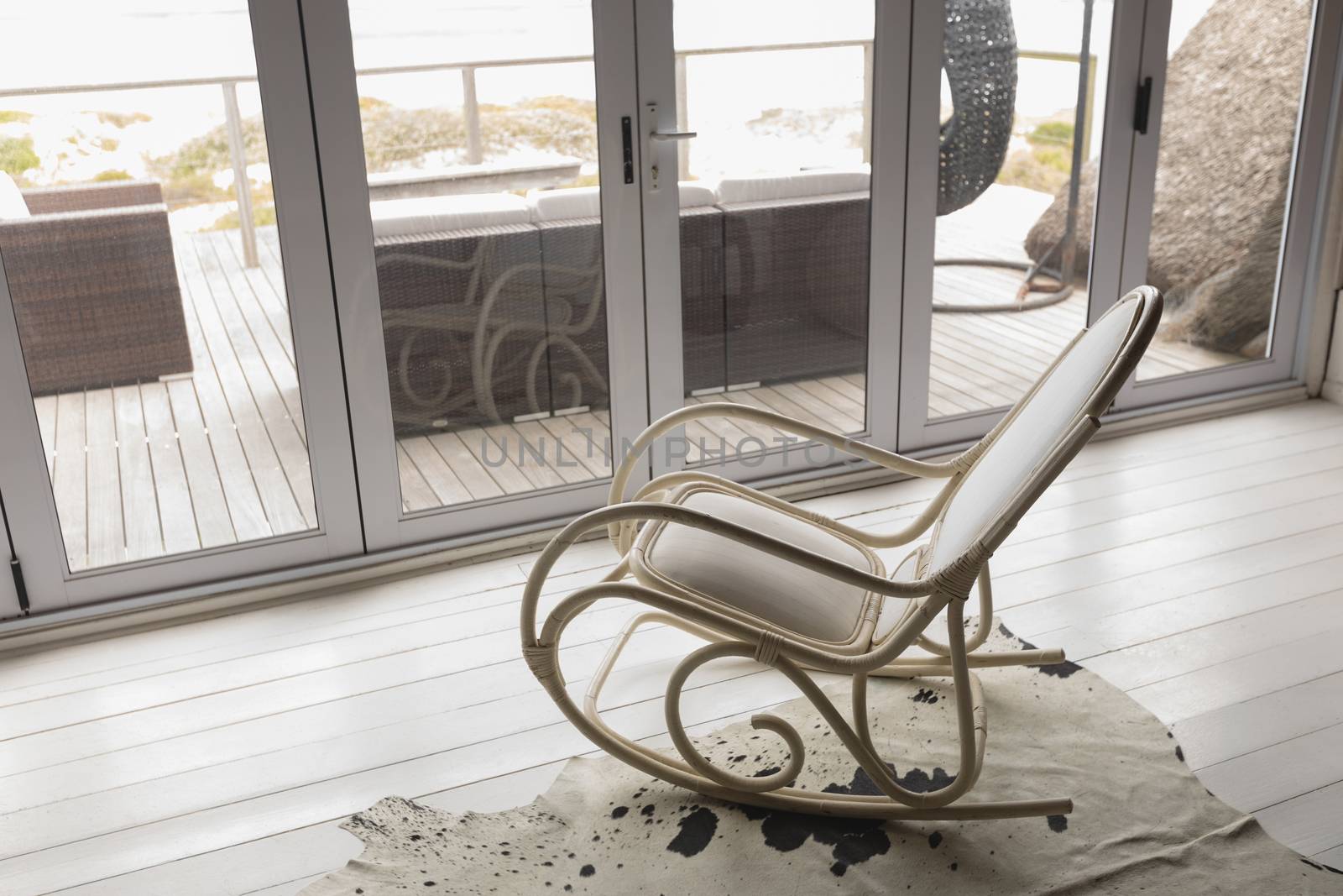 High angle view of an empty modern rocking chair placed near the window at home