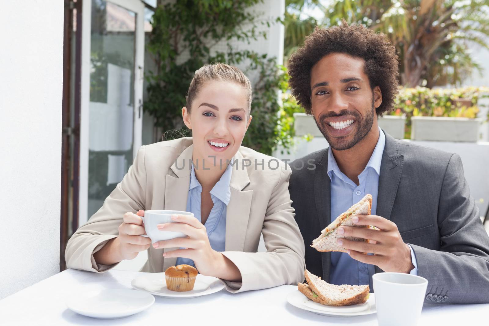 Happy business people on their lunch outside at the coffee shop