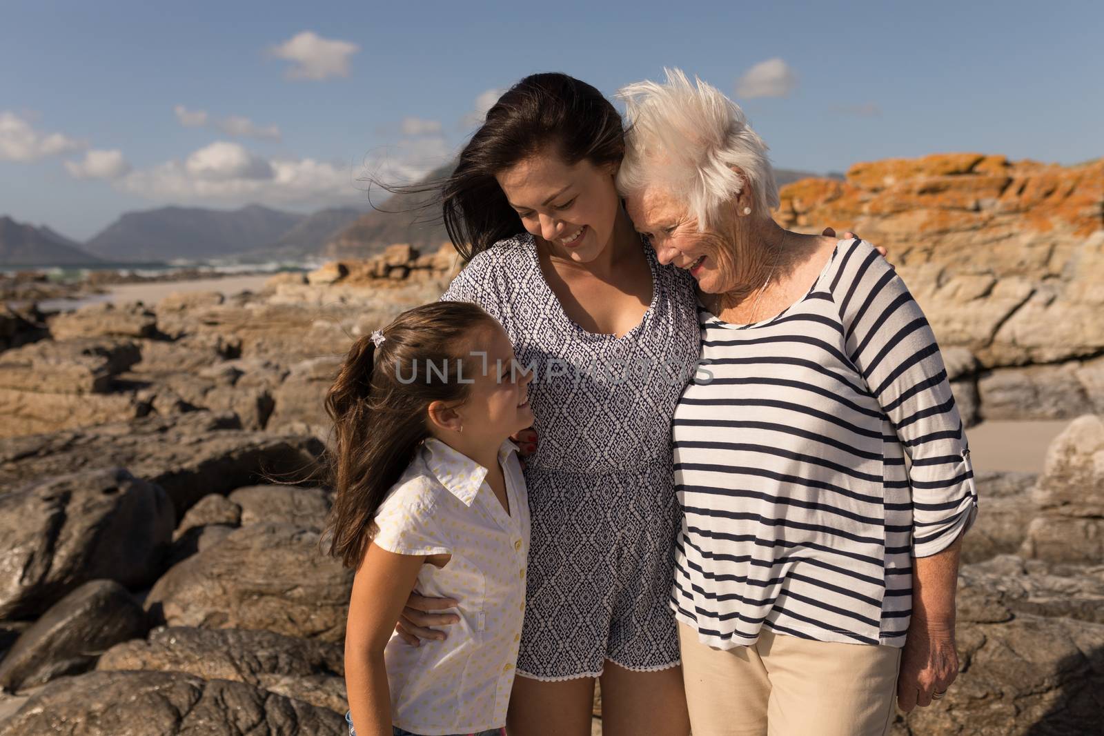 Family looking each other on beach by Wavebreakmedia