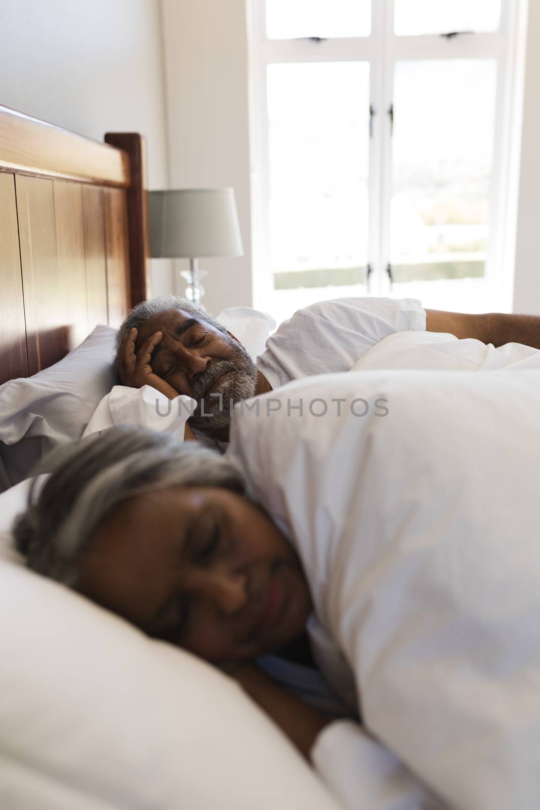 Close-up of a senior African American couple sleeping in bedroom at home