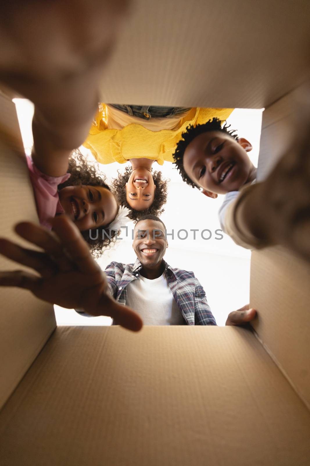 Upward view of African American family unpacking their belongings at home by Wavebreakmedia