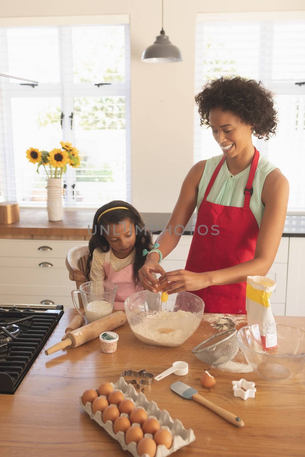 High angle view of African American mother and daughter baking cookies in kitchen at home