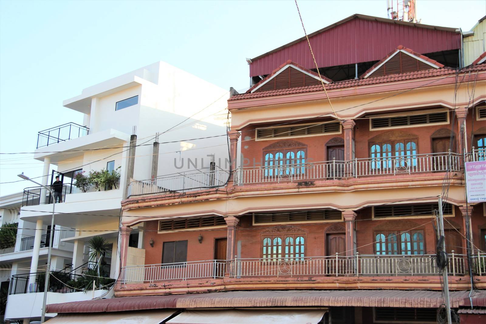 Modern and old house design - asia. the old design of house next to a very modern concrete block house