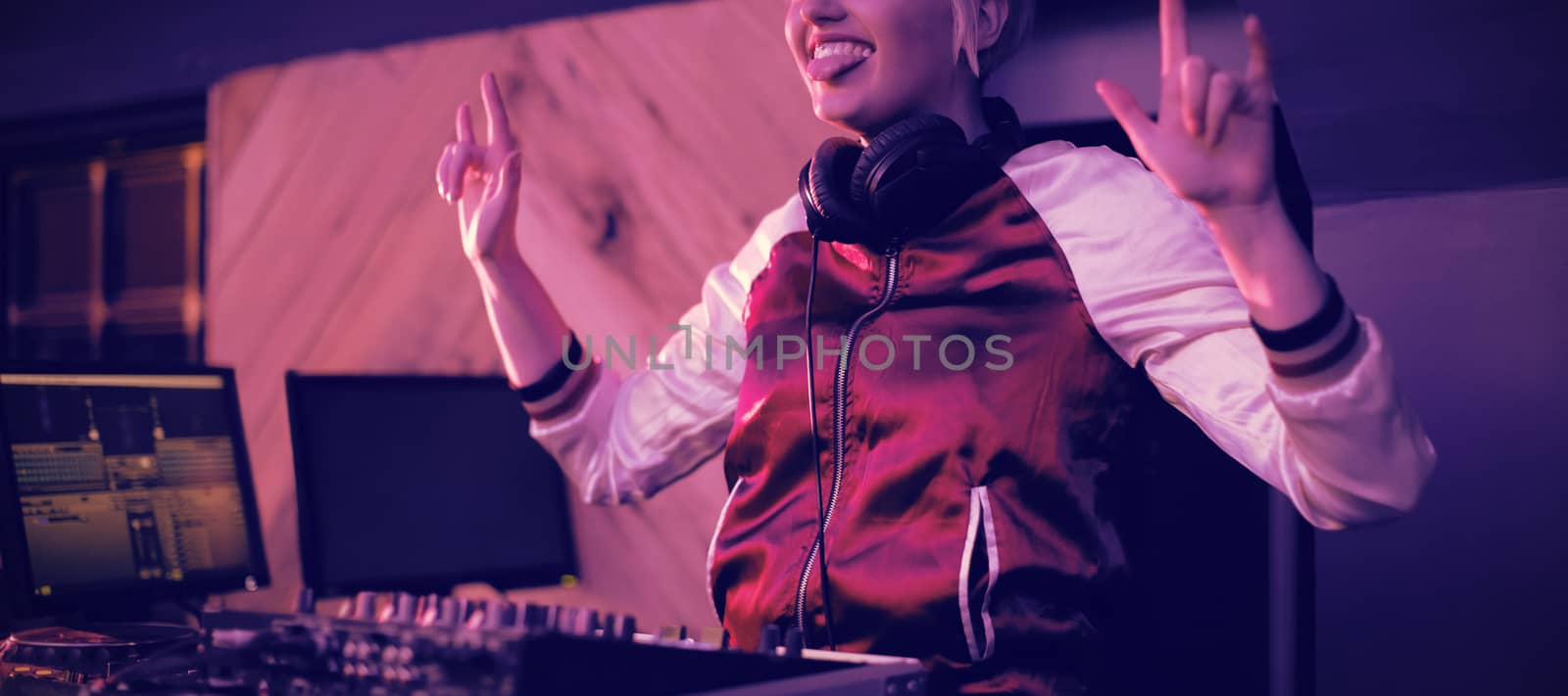Pretty female dj having fun while playing music in bar
