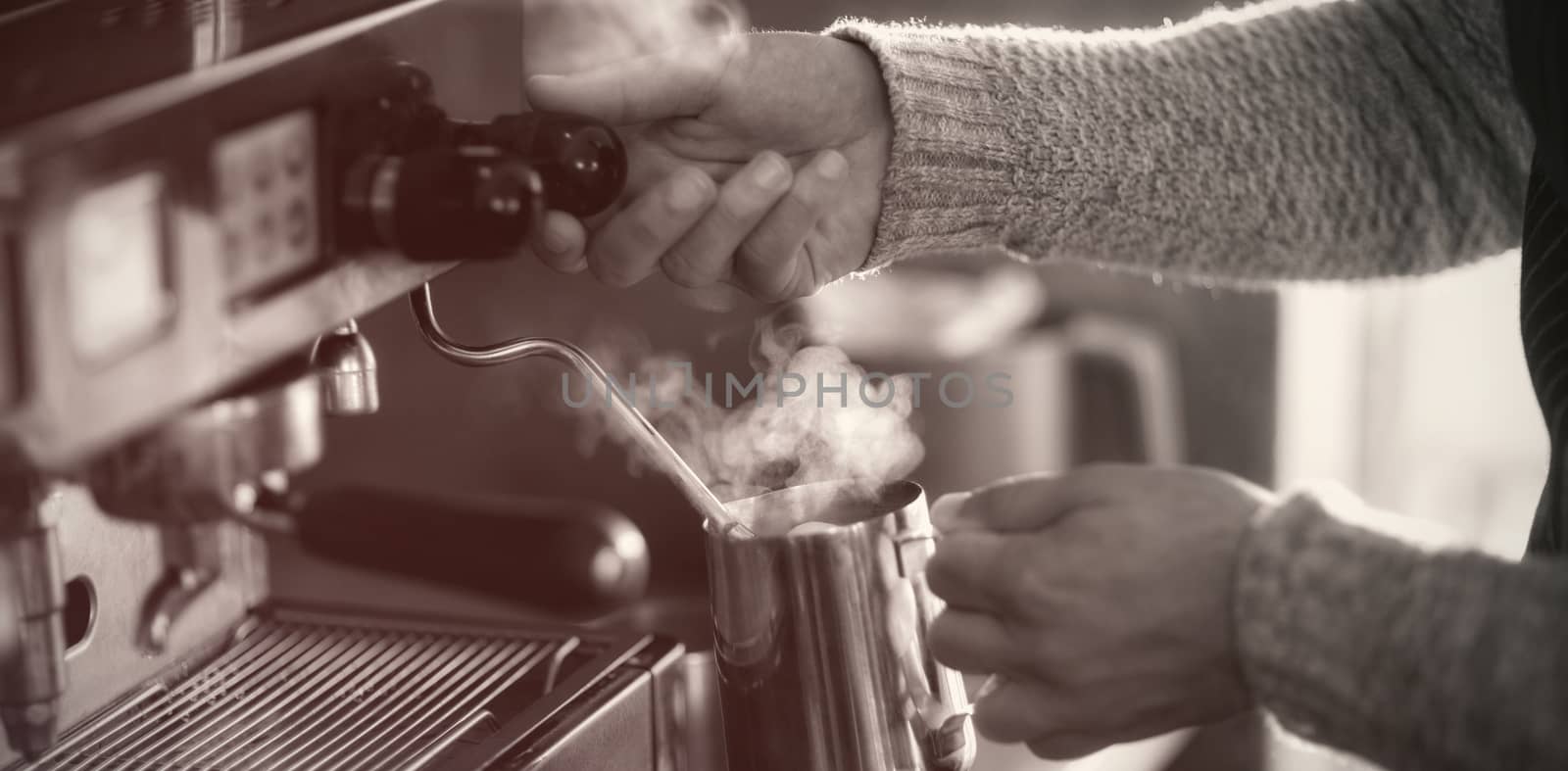 Waiter making cup of coffee at counter in kitchen at cafÃ©, Close-up