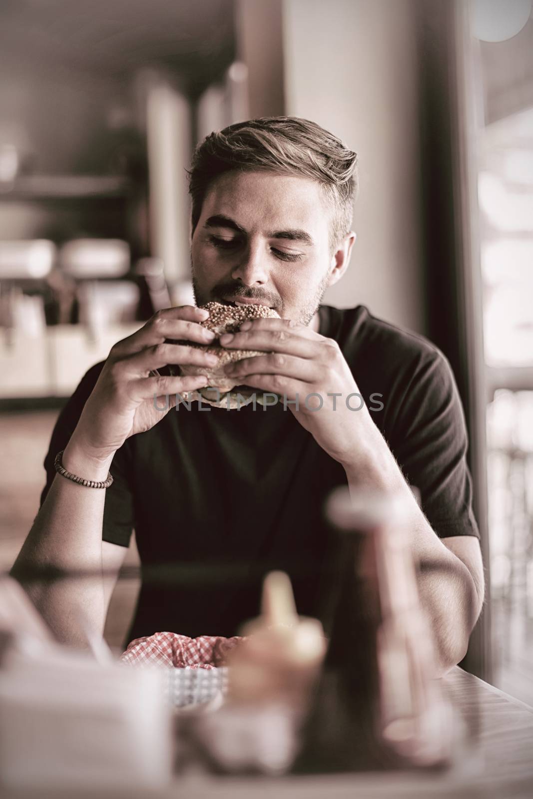 Man eating burger in restaurant