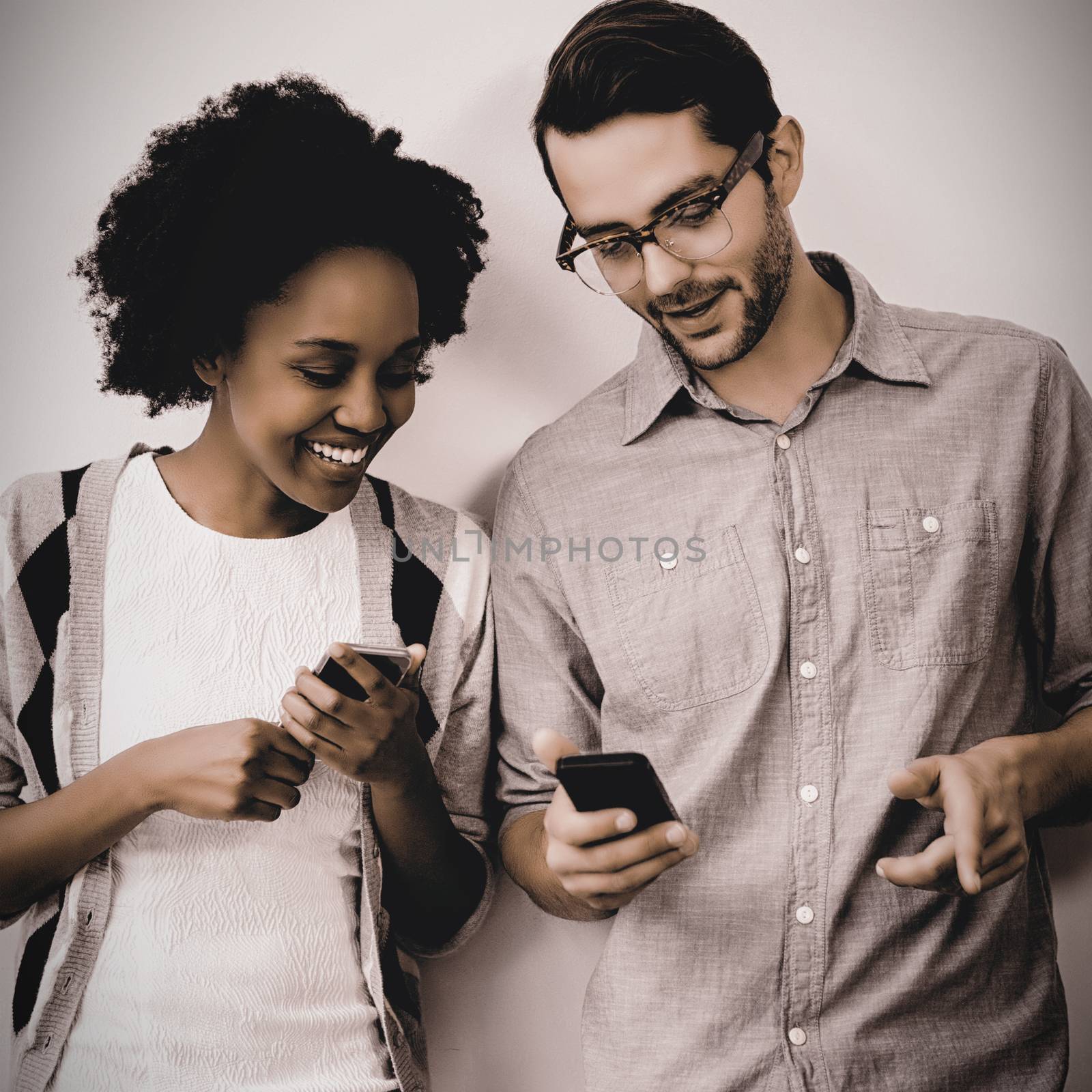 Man and woman using mobile phone by Wavebreakmedia