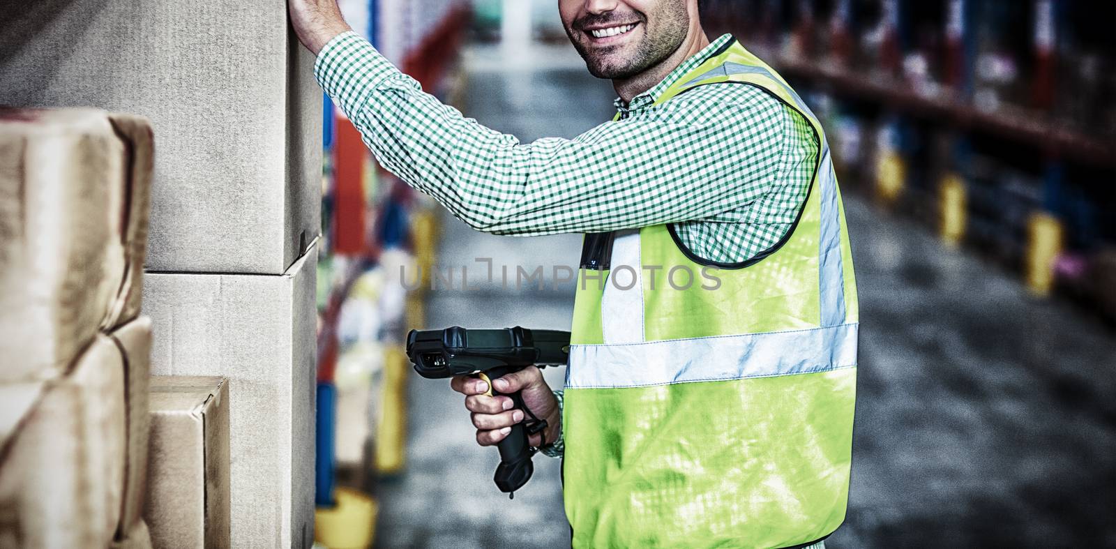 Worker is smiling and posing during work in a warehouse
