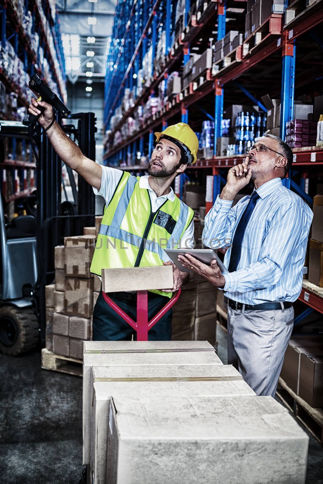 Businessman and warehouse worker in warehouse