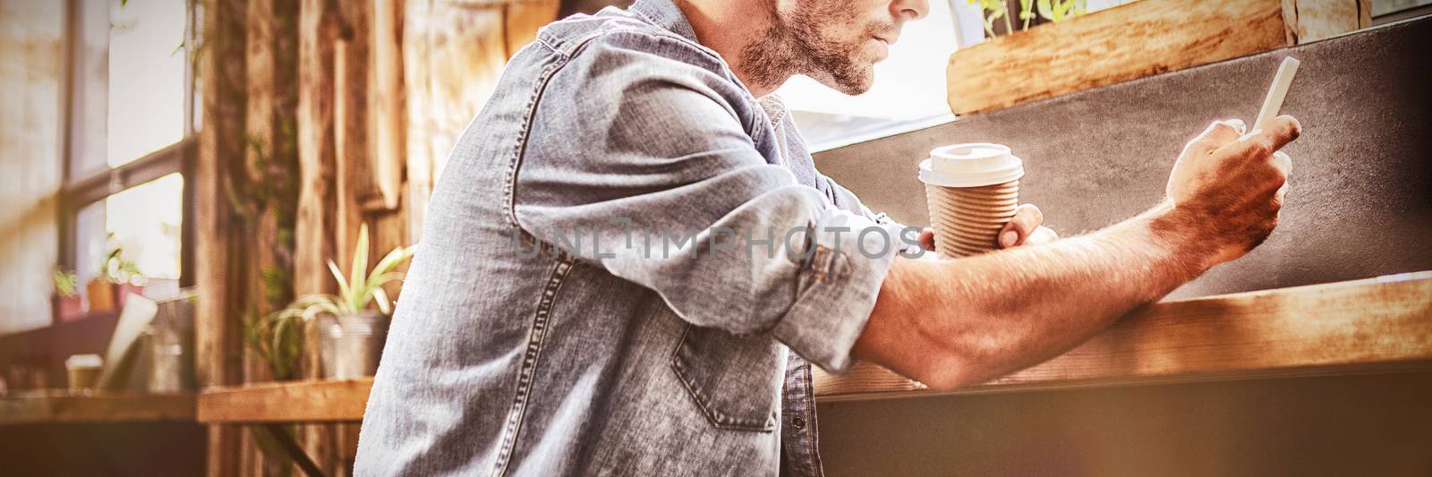Man using a smartphone in the cafe