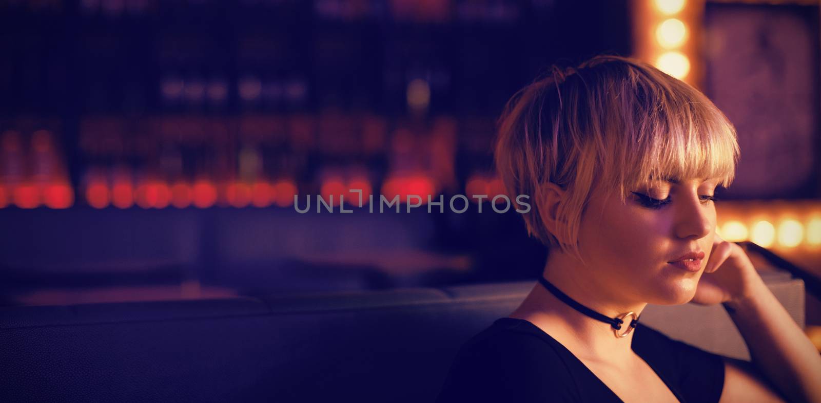 Beautiful woman sitting on a couch in bar