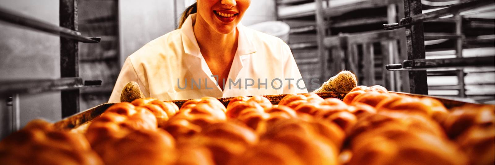Female baker working in bakery shop