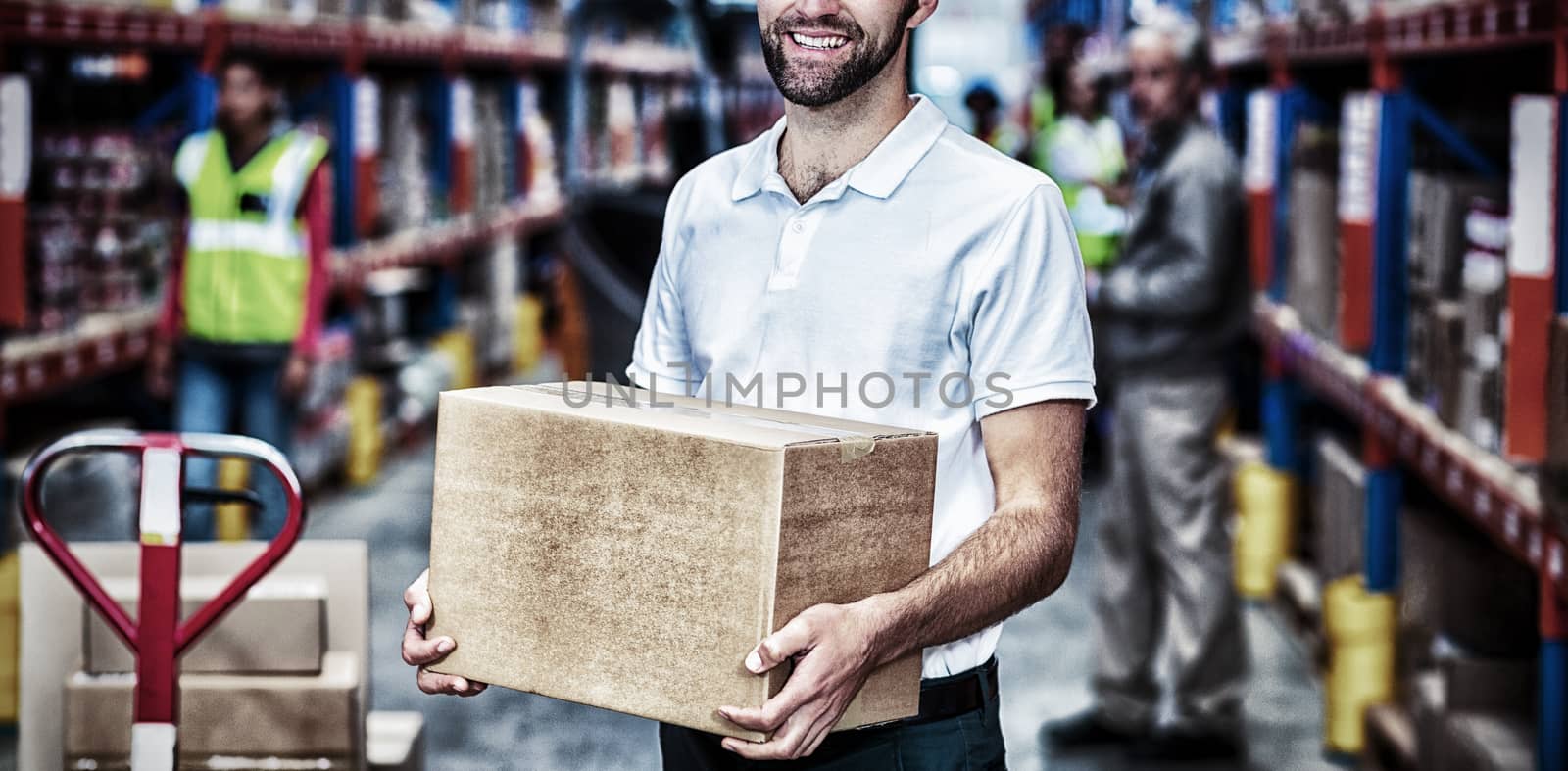 Portrait of worker is holding cardboard boxes and smiling to the camera in a warehouse