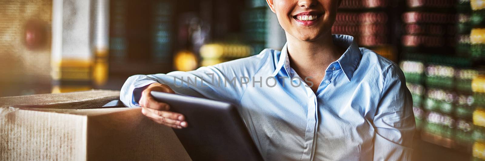 Portrait of female factory worker standing with digital tablet in factory