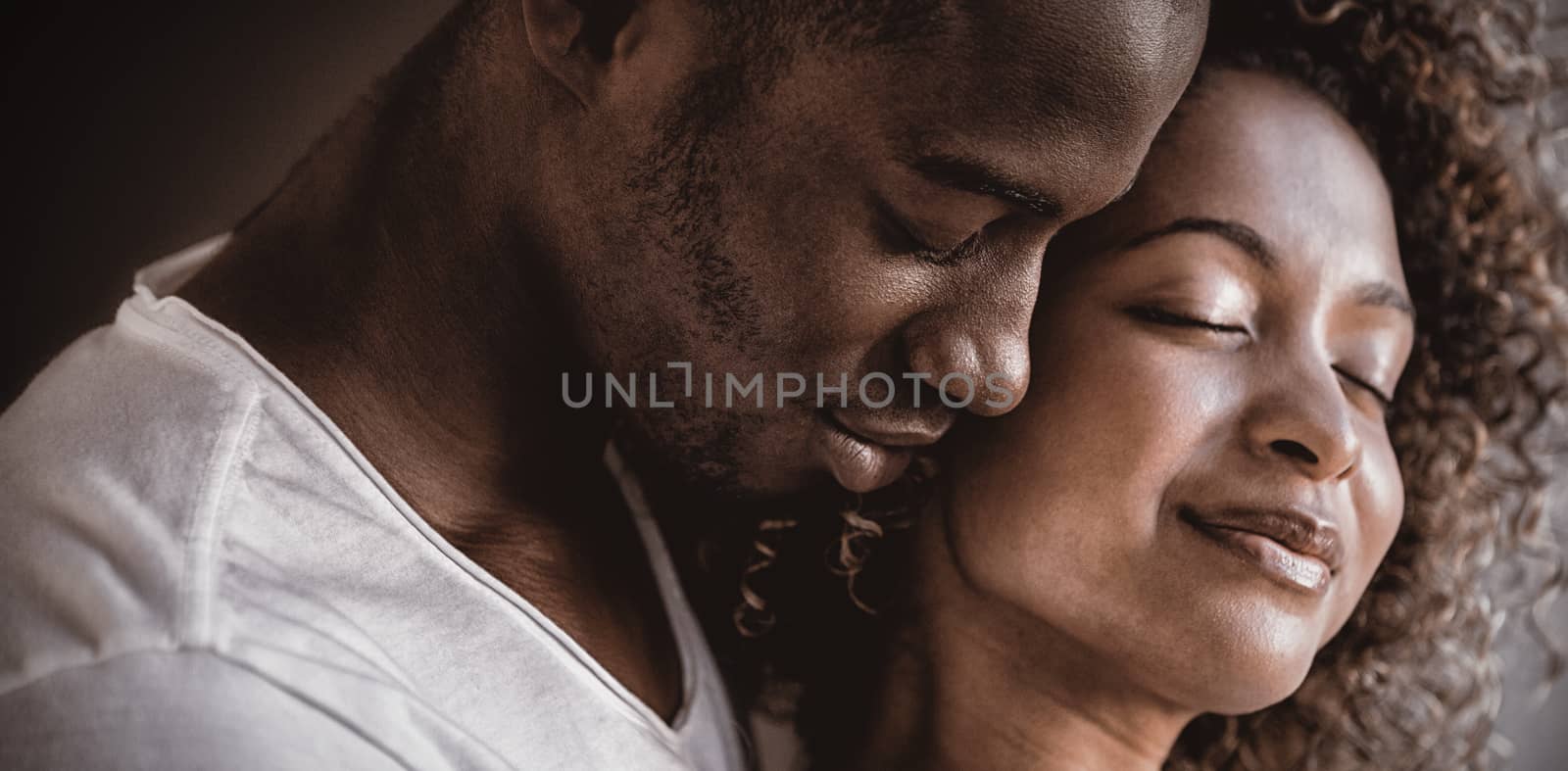 Young couple embracing together by Wavebreakmedia