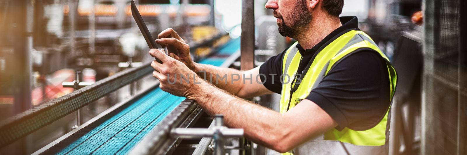 Factory worker using a digital tablet in factory by Wavebreakmedia